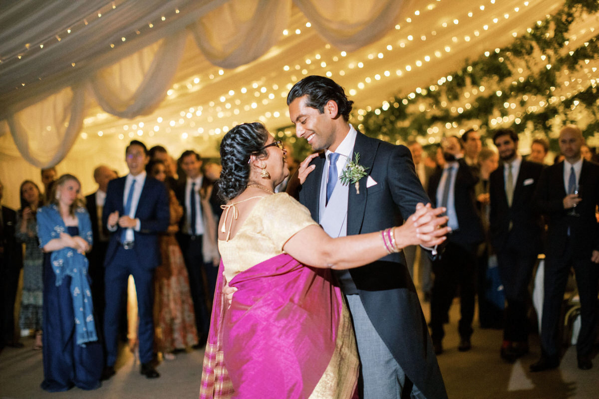 groom and mother dance at Indian wedding