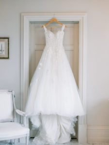 wedding dress hanging up in bridal suite
