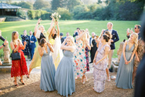 bridesmaids catching bouquet