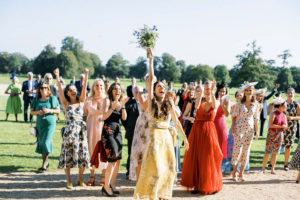 Bridesmaid catching bouquet at Goodwood House