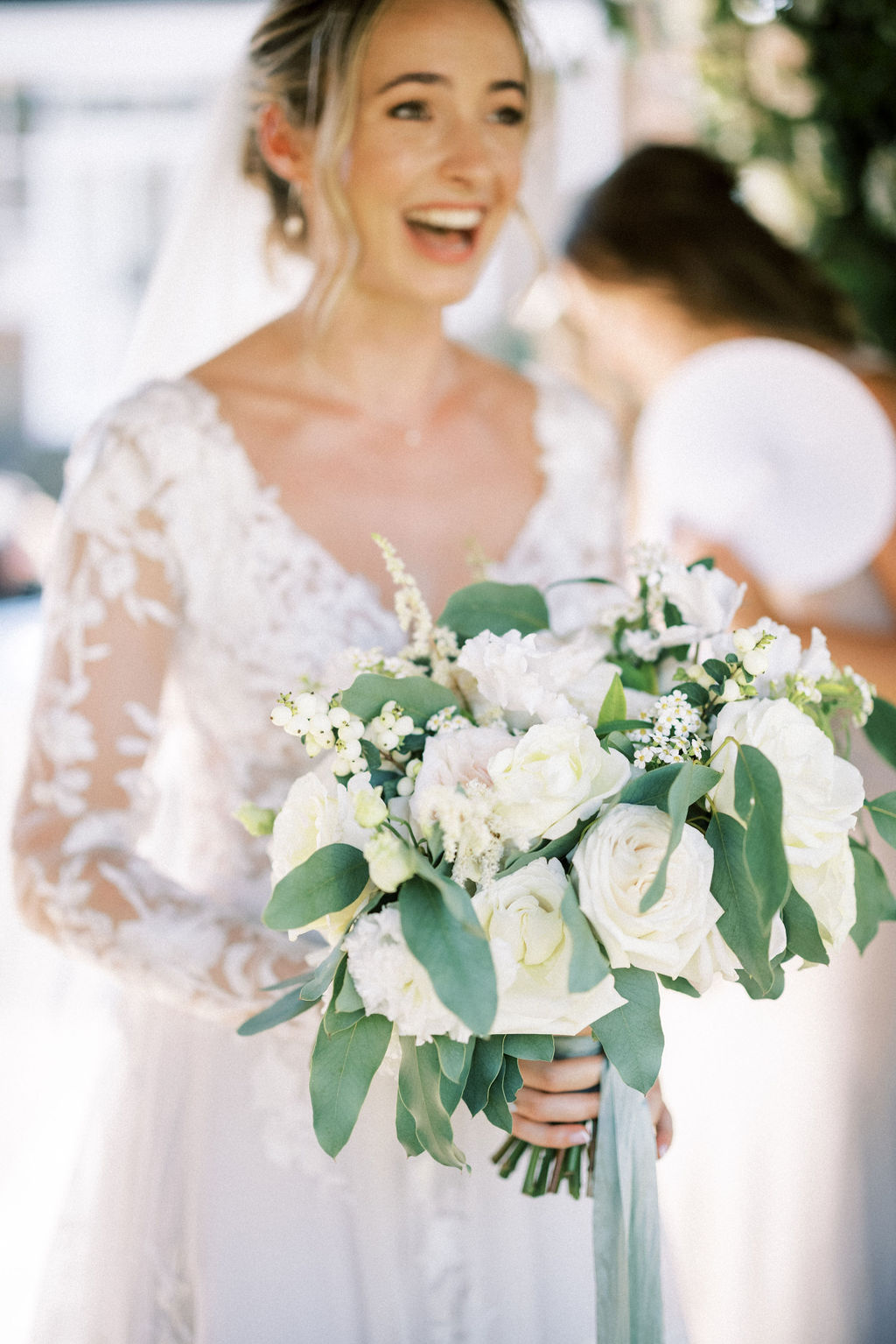 Bride holding green white and blush bouquet for garden marquee wedding