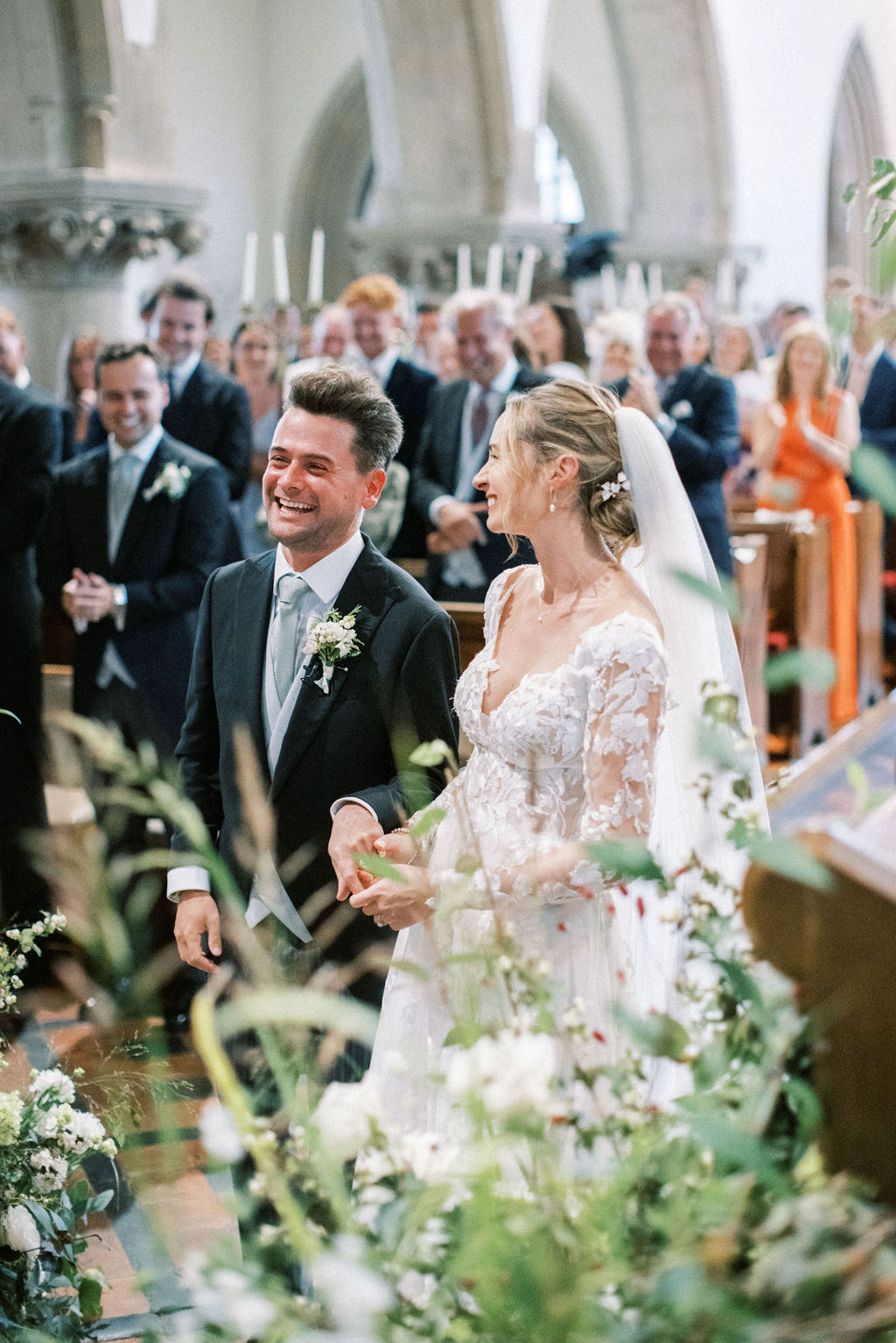 Bride an groom laughing in church