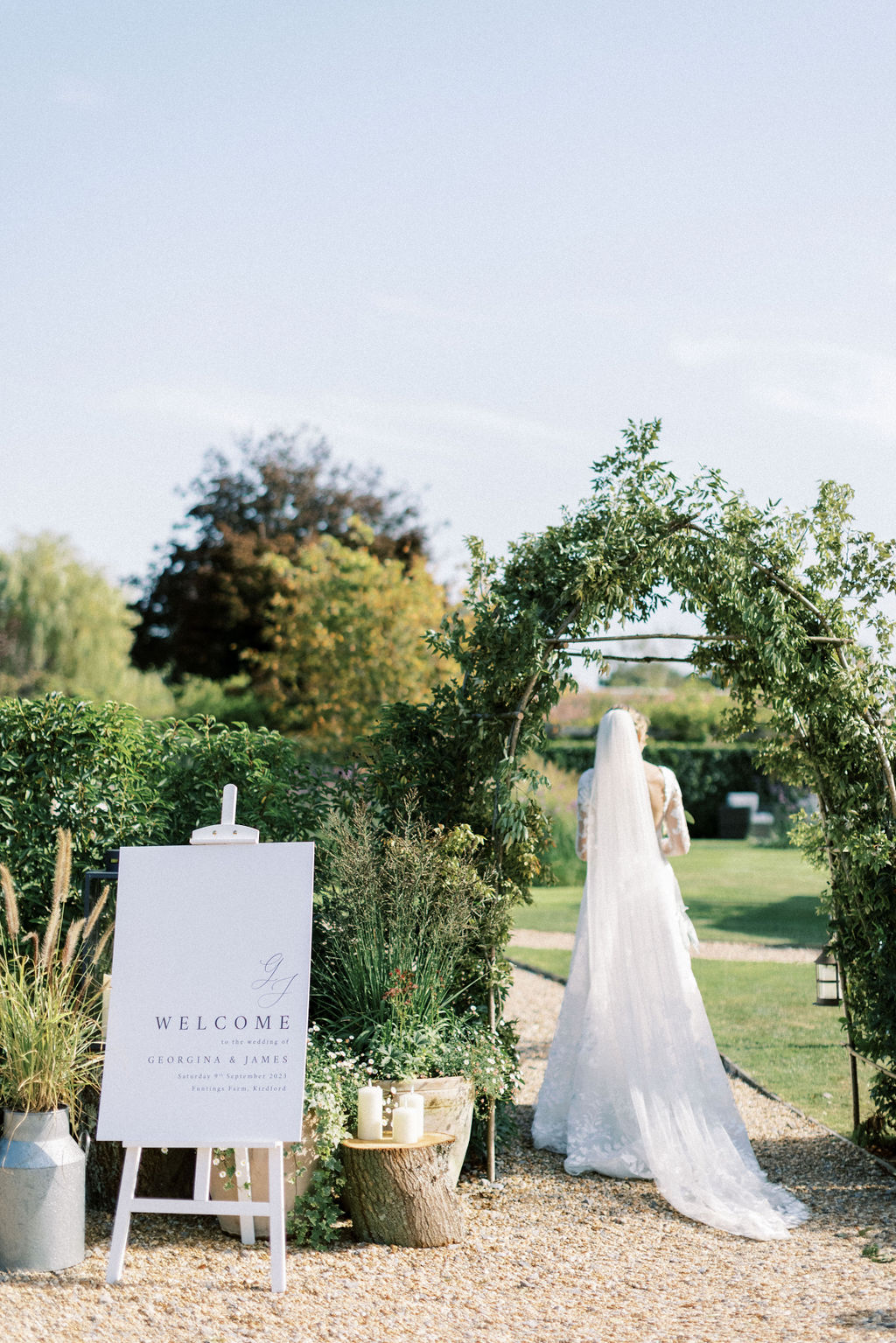 Bride arriving at garden marquee wedding reception