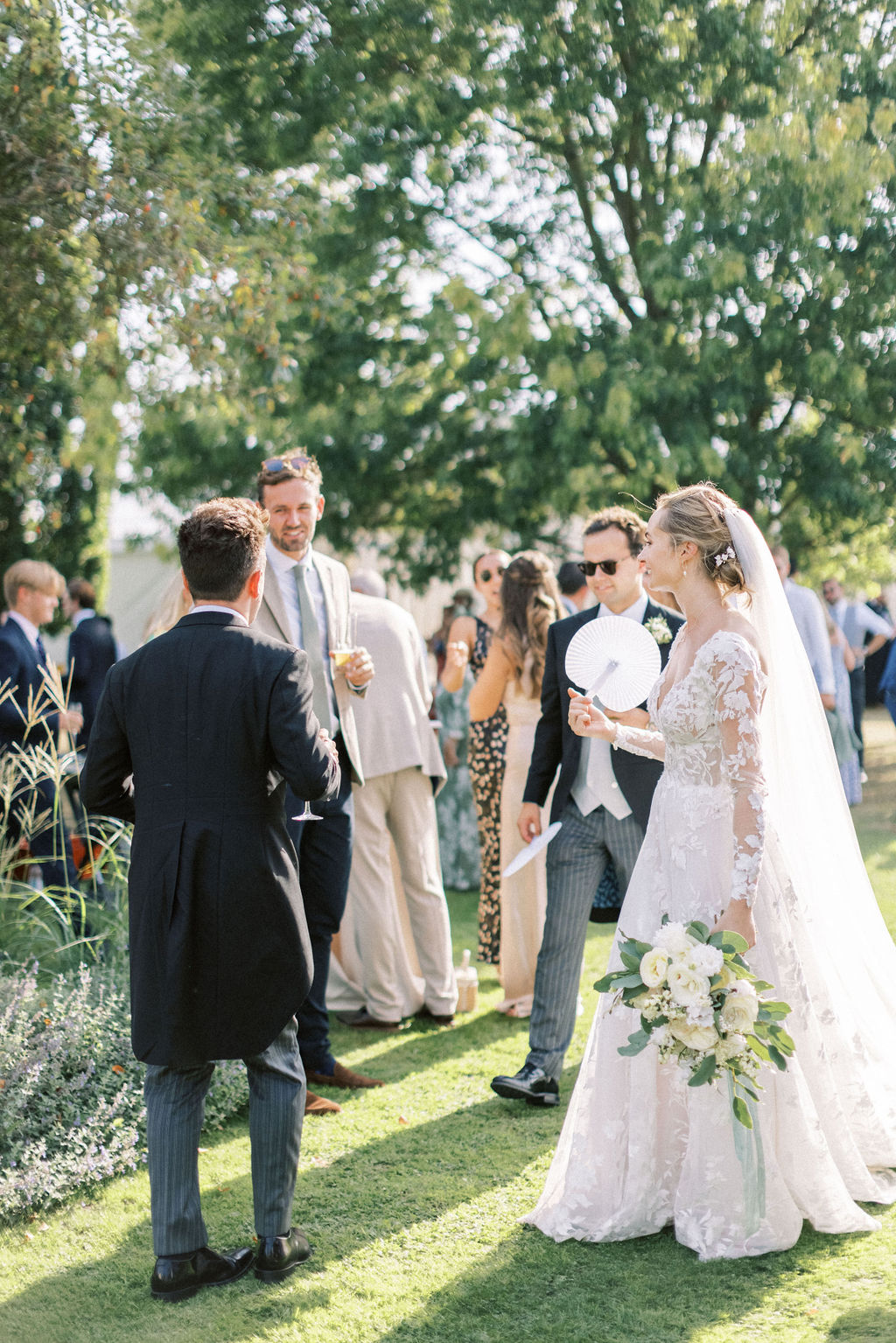 bride and groom mingling in garden at home wedding