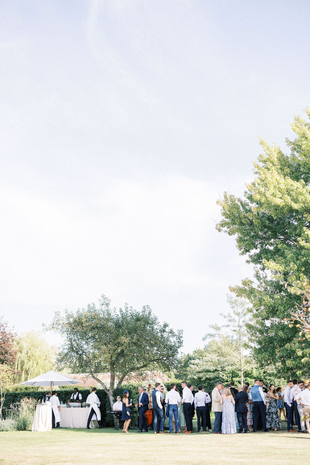 Guests mingling in garden at home wedding