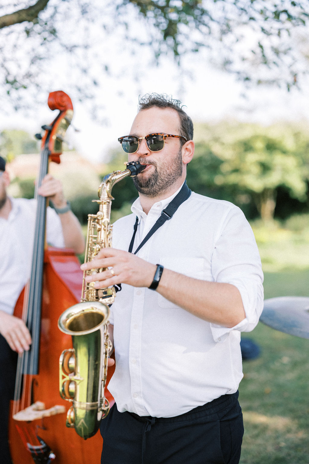 Saxophonist at garden marquee wedding