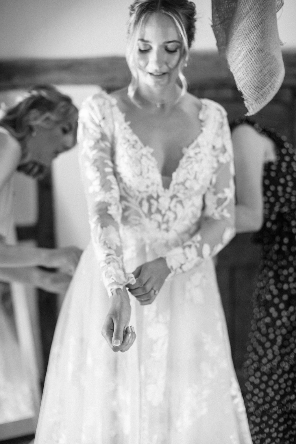 bride putting on wedding dress on wedding morning