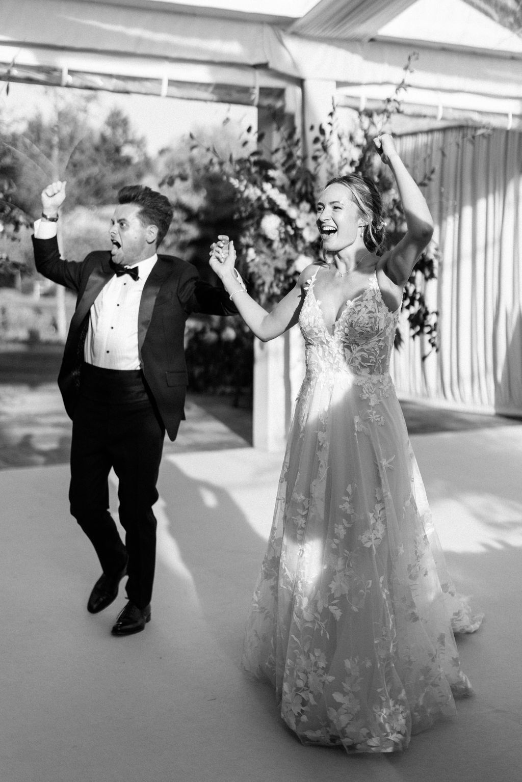 bride and groom entering marquee