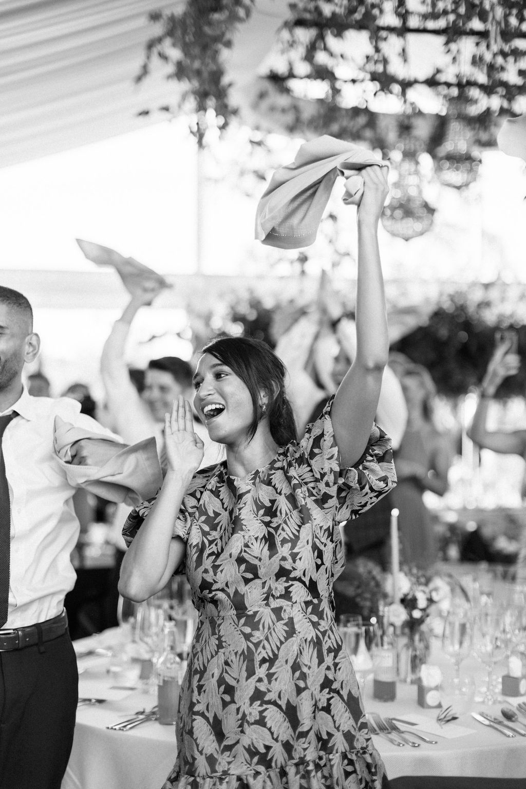 guests waving napkins at wedding breakfast