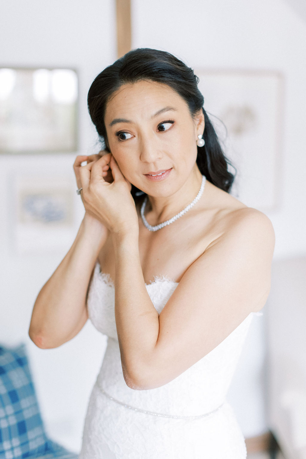 bride putting on earrings