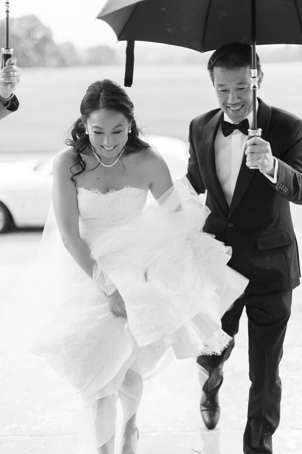 bride and groom under umbrella for Blenheim Palace wedding