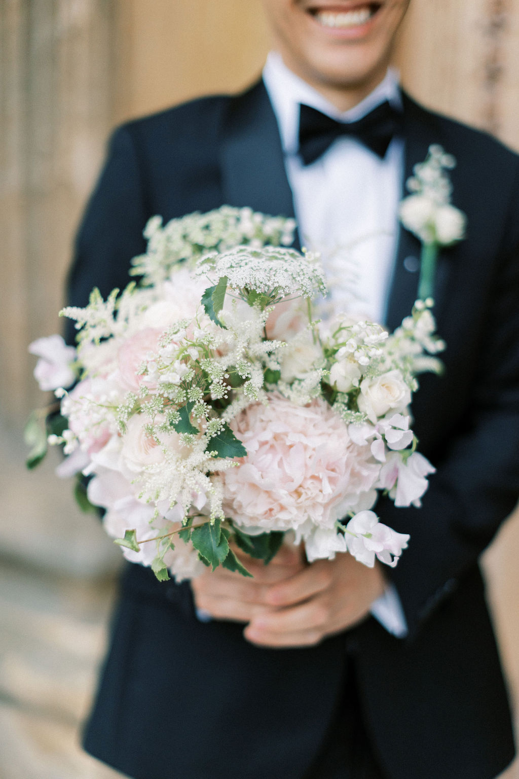 groom holding bouquet