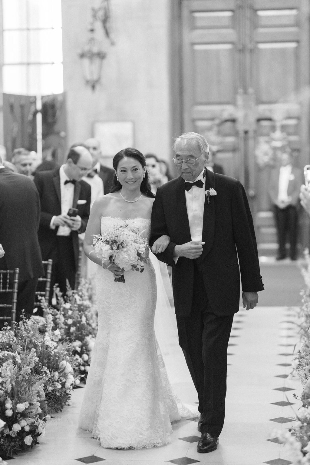 bride walking down the aisle with father at Blenheim Palace wedding