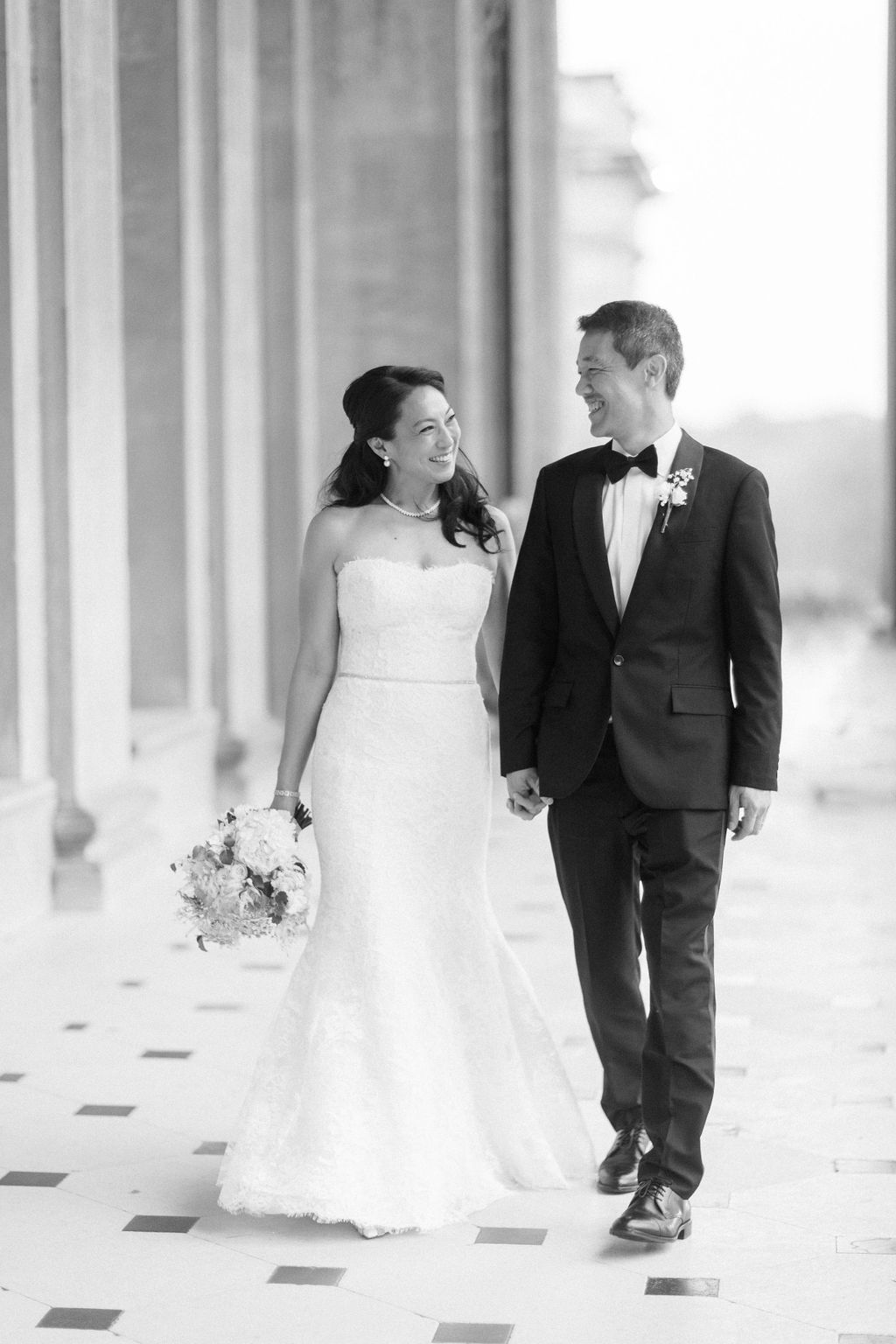 bride and groom walking through balustrades at Blenheim Palace