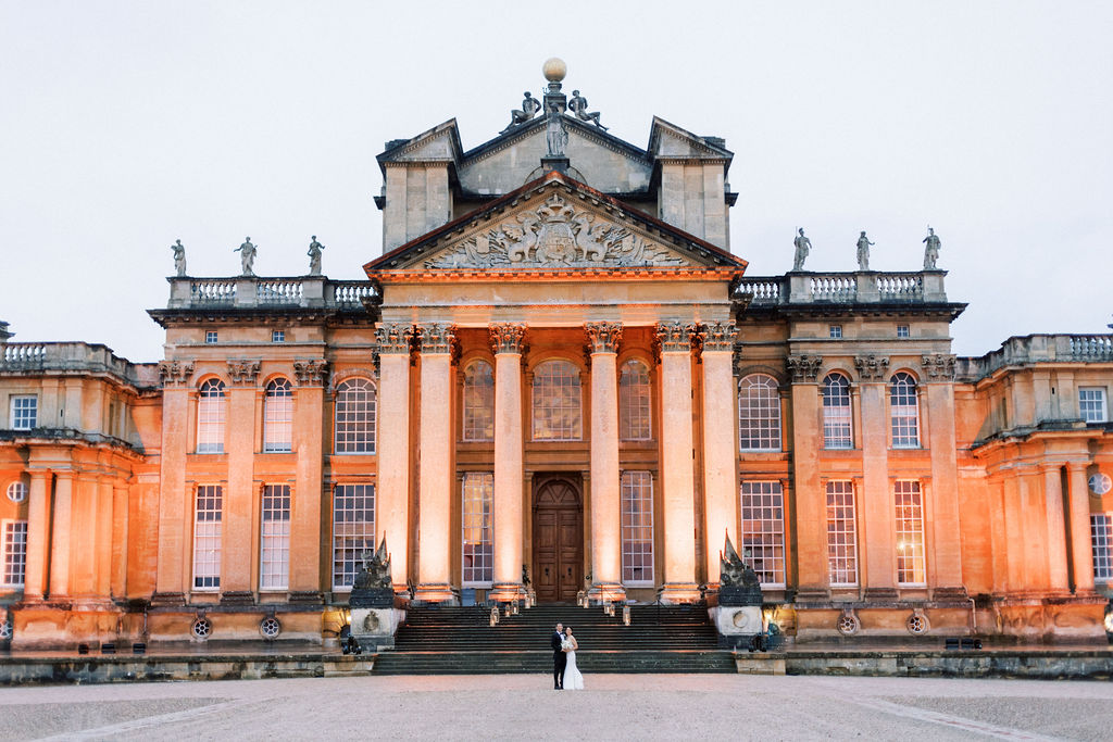 Bride at groom in front of the building at Blenheim Palace Wedding