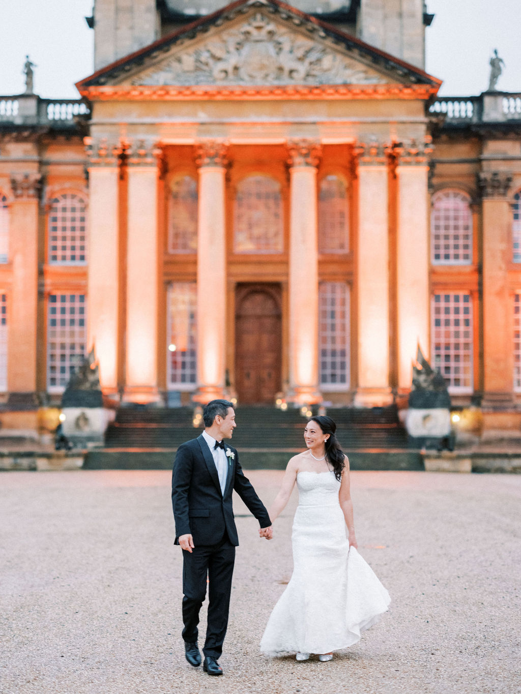 Bride at groom in front of the building at Blenheim Palace Wedding