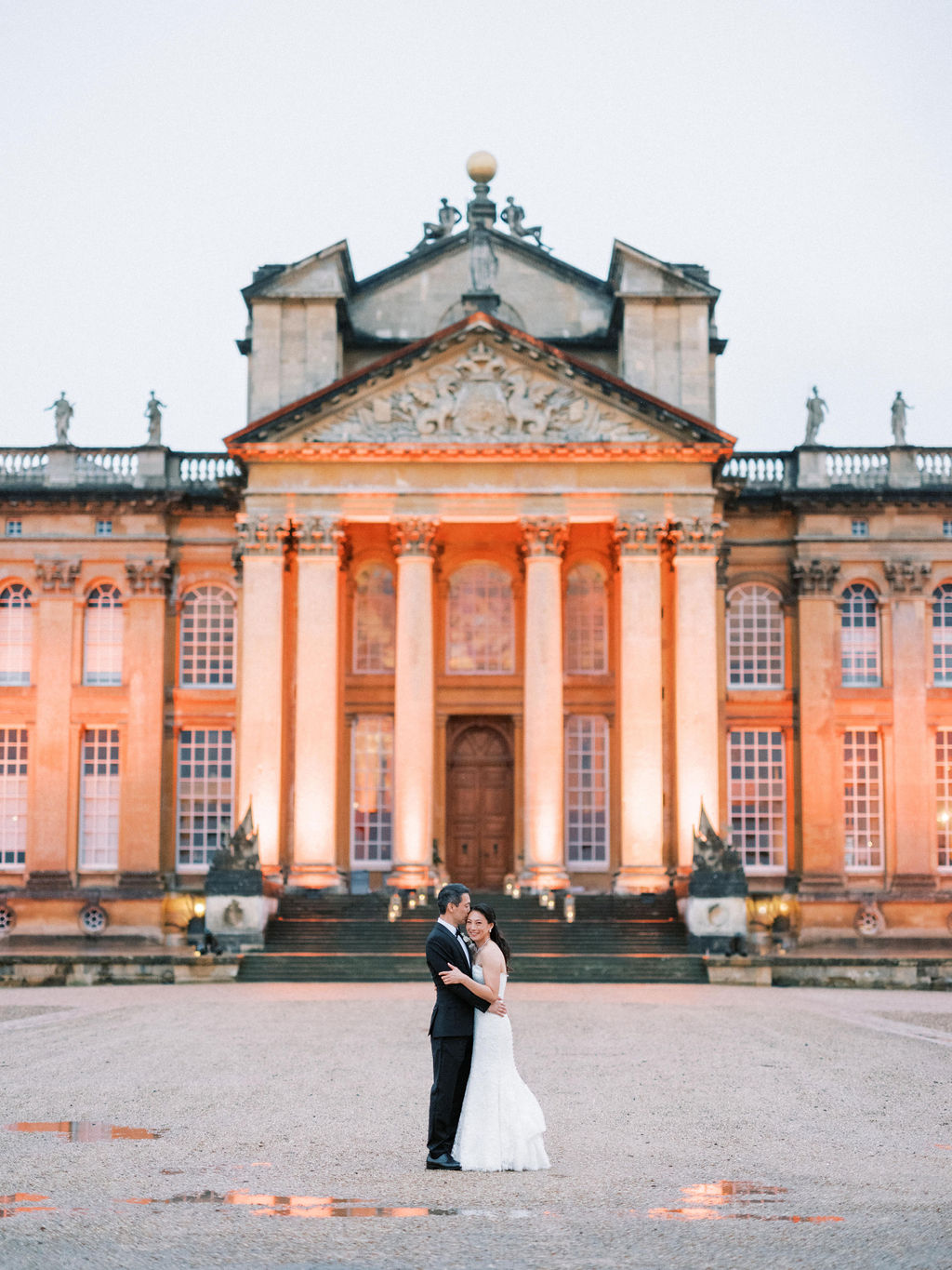 Bride at groom in front of the building at Blenheim Palace Wedding