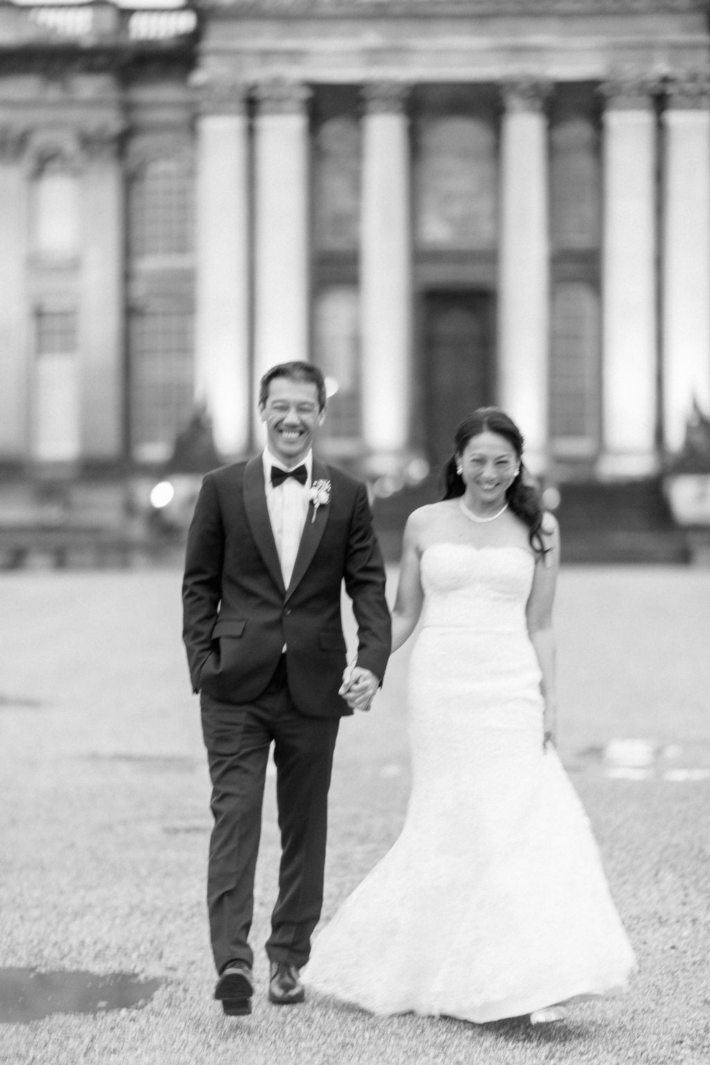 Bride at groom in front of the building at Blenheim Palace Wedding