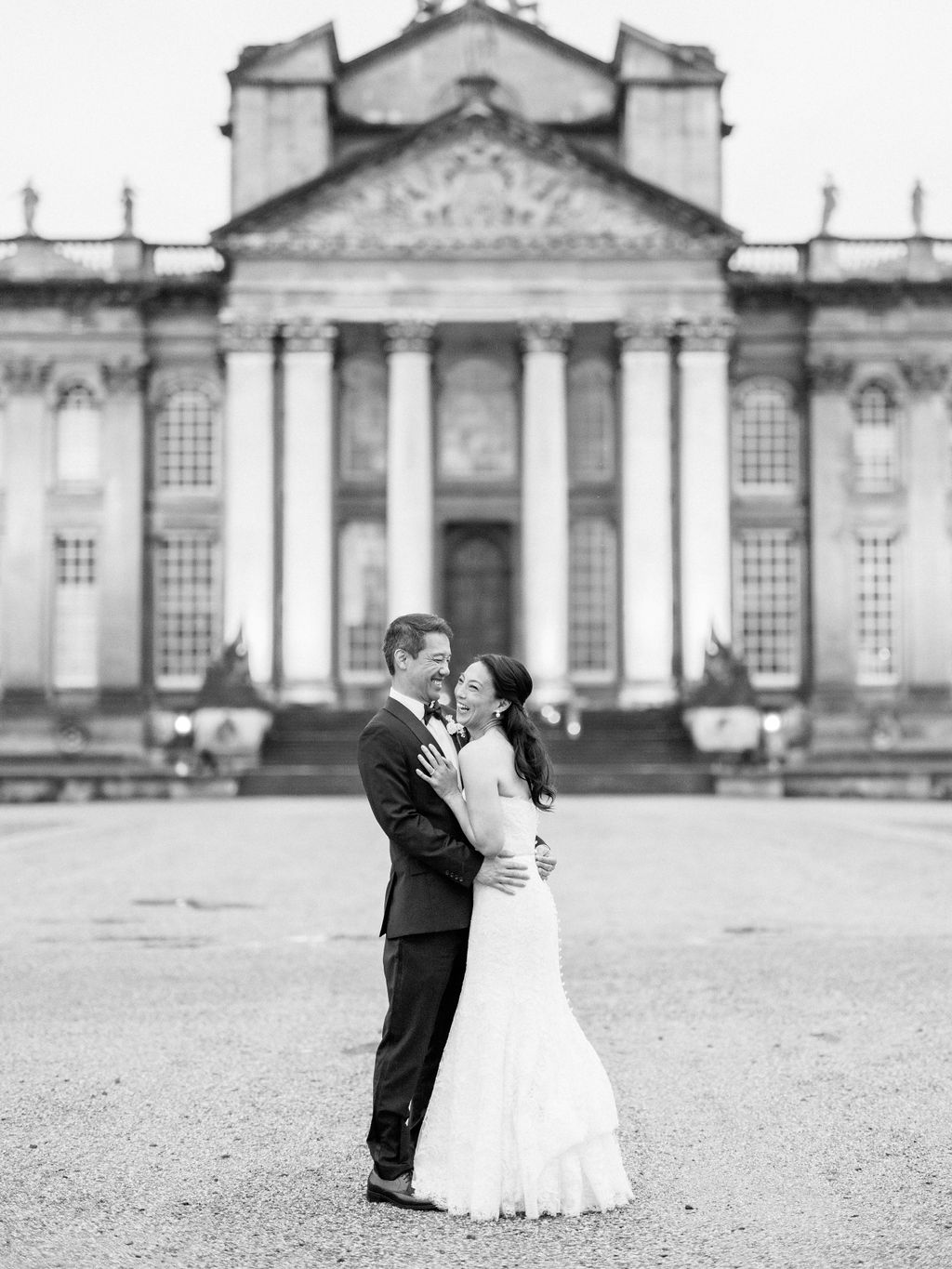 Bride at groom in front of the building at Blenheim Palace Wedding