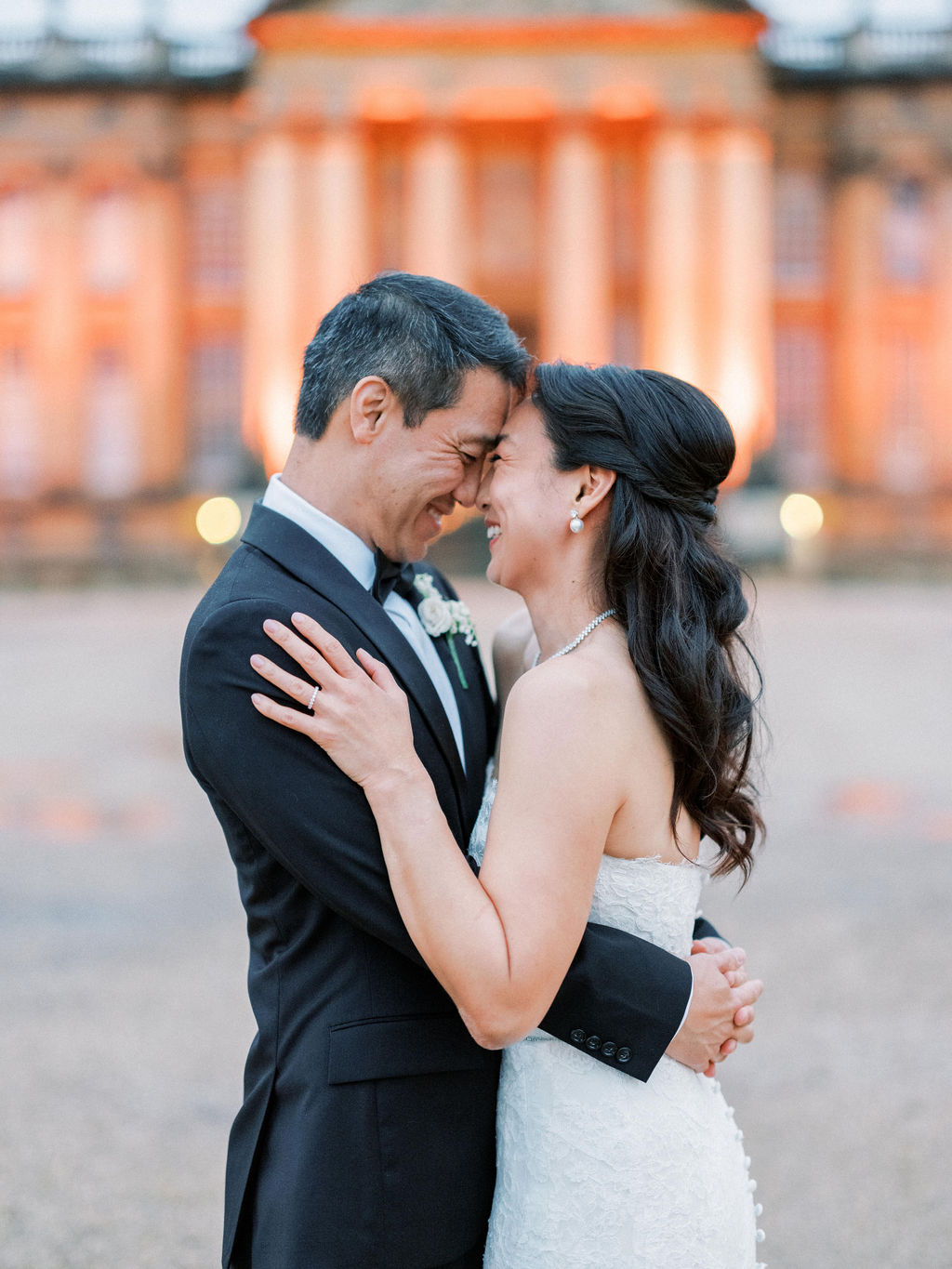 Bride at groom in front of the building at Blenheim Palace Wedding