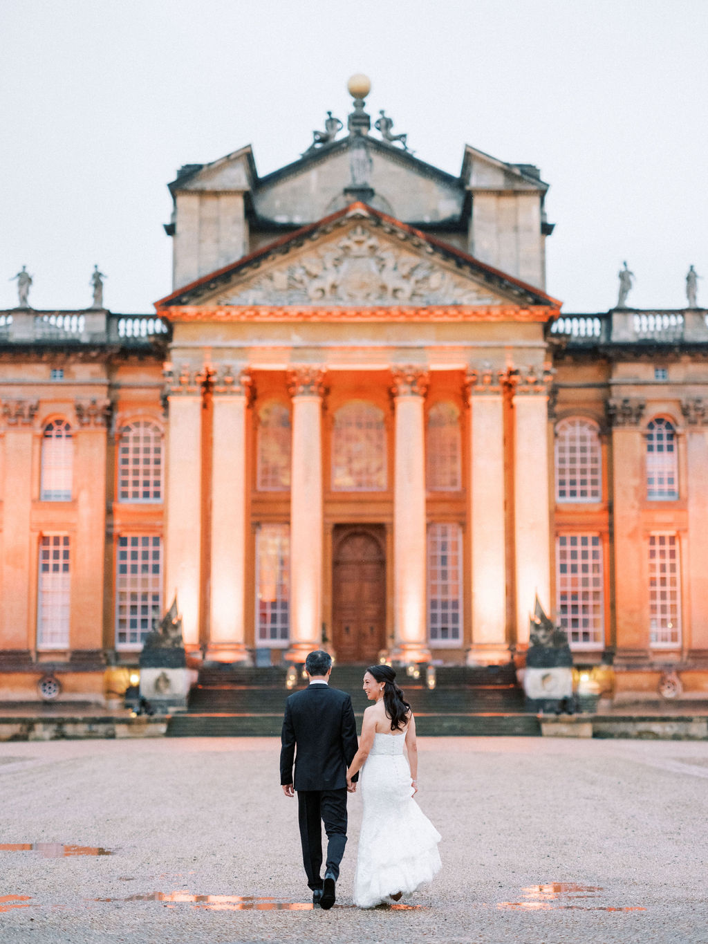 Bride at groom in front of the building at Blenheim Palace Wedding