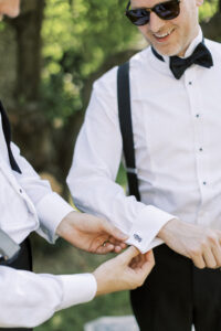 Groom putting on cufflinks